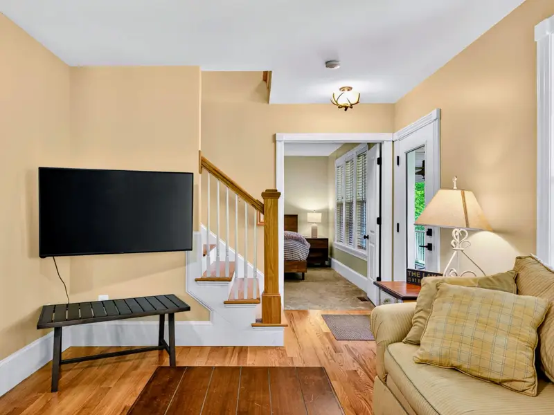 Living Room - The space the family ends up in, with the TV, fireplace, and easy access to the kitchen and deck.