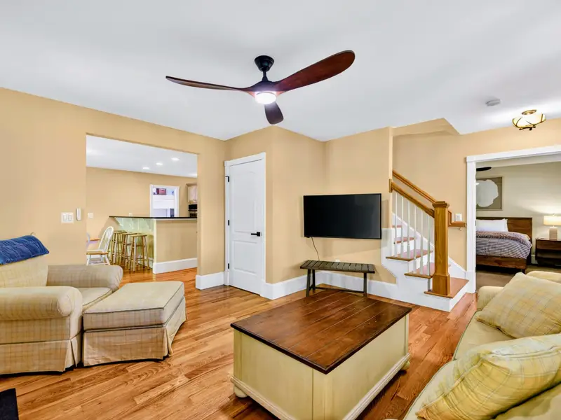 Living Room - Open layout flowing toward the stairs and rest of the home, keeping everyone connected.