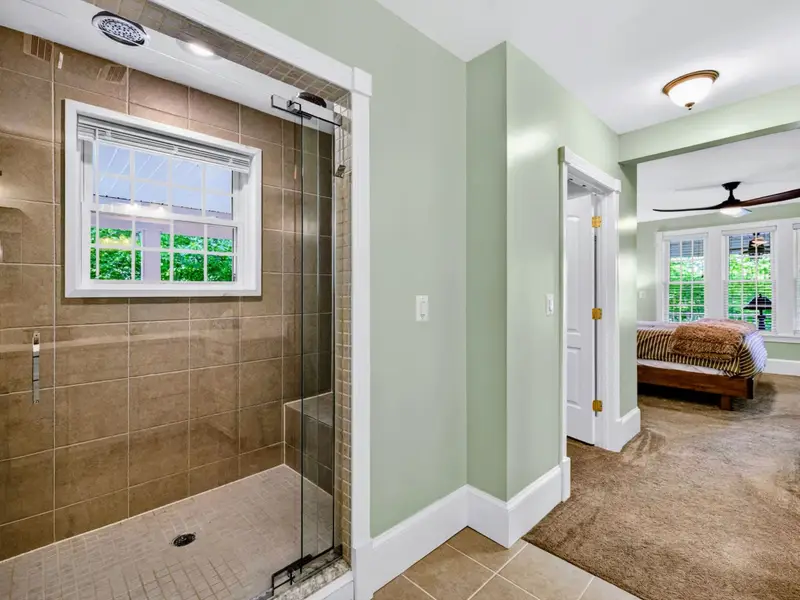 Primary Bath - Tucked-back walk-in shower with the closet just beyond.