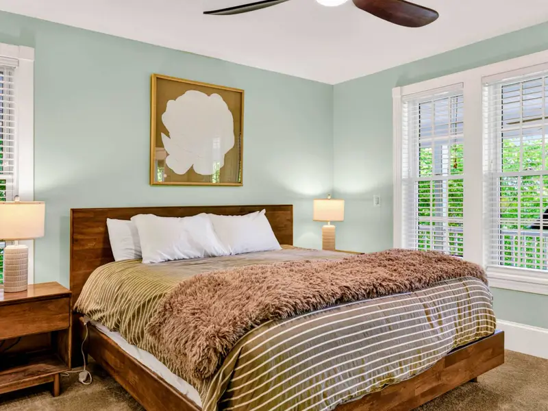 Primary Suite - The main-level suite stays connected to the deck and the rest of the home without ever feeling busy.