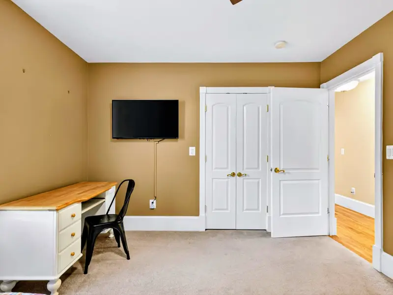 Twin Bedroom - Wall-mounted TV and tucked-in desk give this room a place to retreat for both movies and downtime.