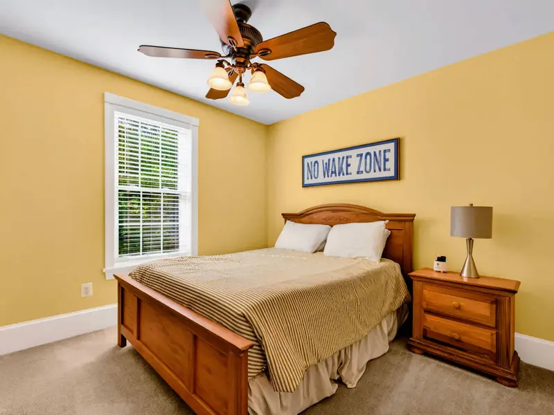 King Bedroom - Sunny yellow walls and a Lake Anna 'No Wake Zone' sign make this room feel like vacation.