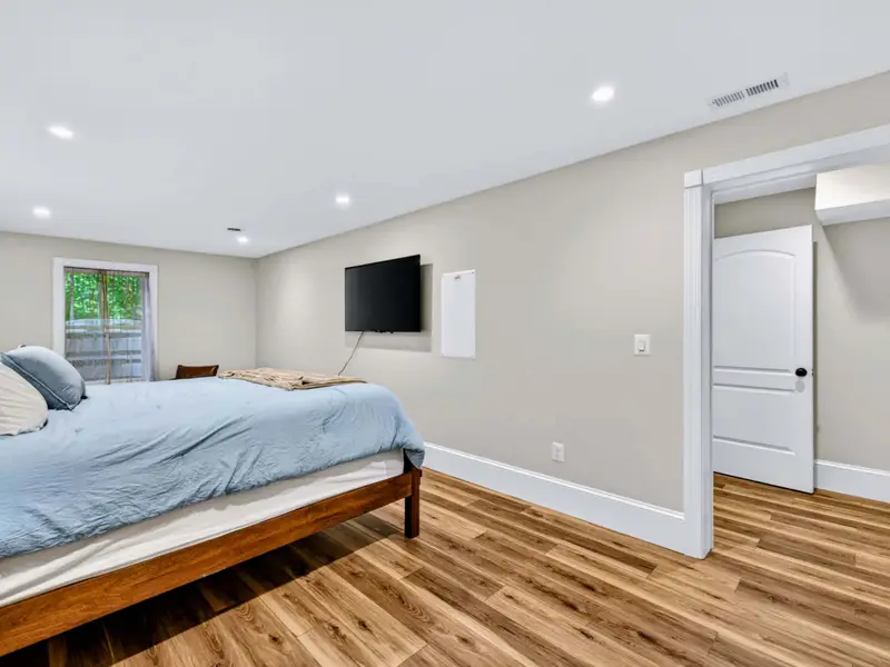King Bedroom - The lower-level suite is bright and quiet, with an ensuite bath just through the door.