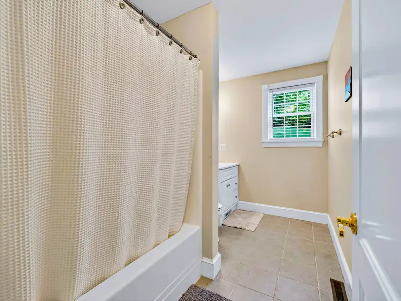 Hall Bath - Full tub-shower combo with natural light, set up for everyday use without feeling cramped.