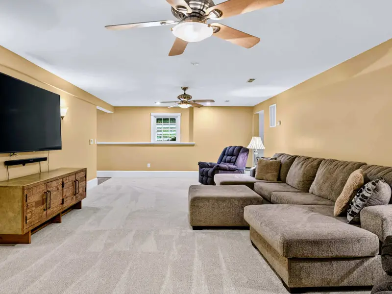Family Room - Plush sectional and recliners angled toward the big TV, perfect for movie nights.