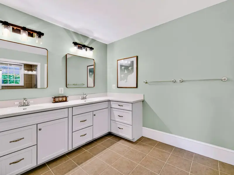 Primary Bath - Dual vanity with deep counters and twin framed mirrors makes morning routines effortless.