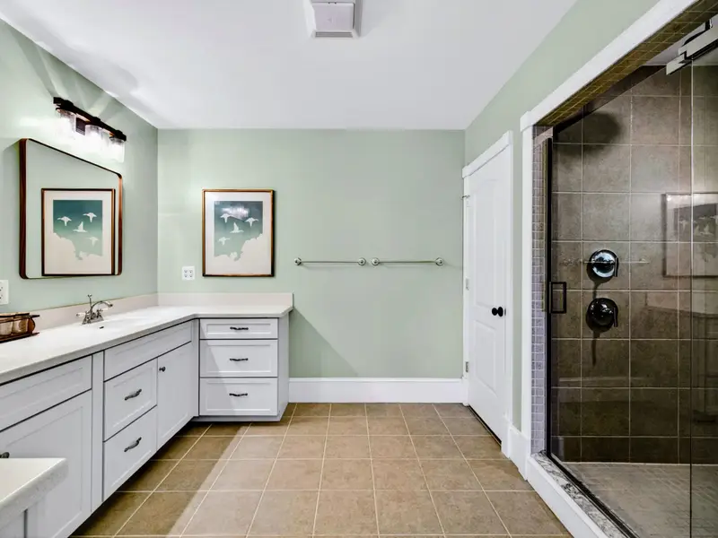 Primary Bath - Walk-in glass shower and dual vanity feel more spa than bathroom.