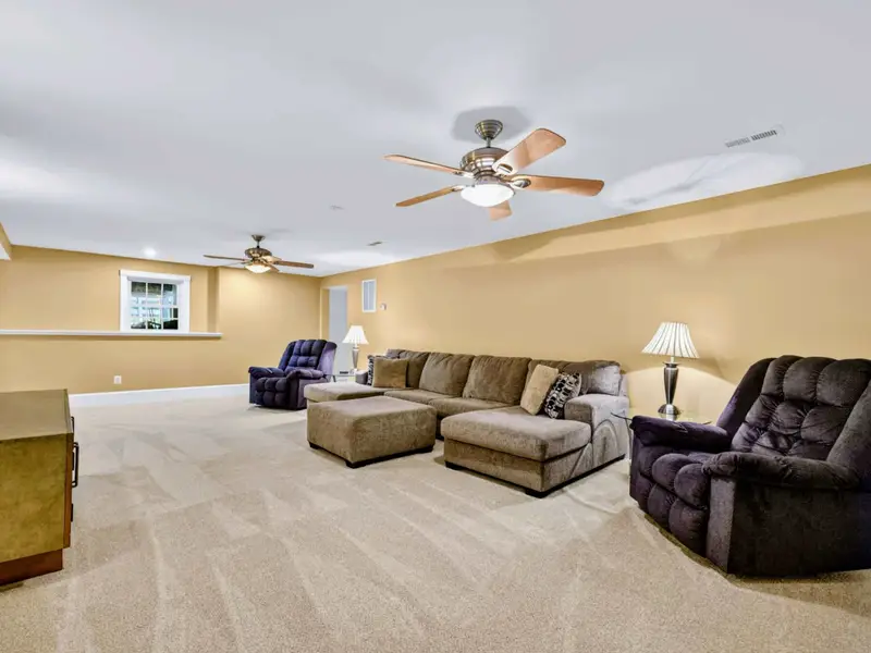 Family Room - Big sectional, two over-sized recliners, and a wall-mounted TV make this the perfect movie night setting.