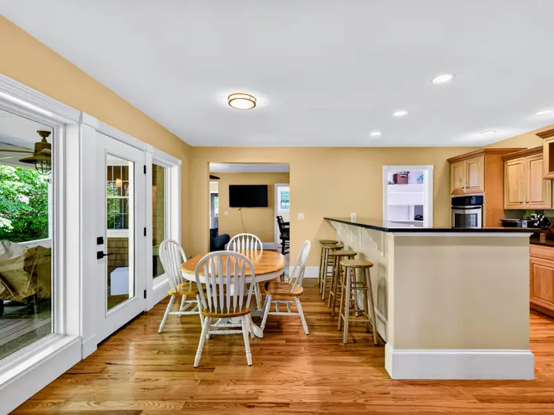 Kitchen - The island anchors the room, with the dining nook just behind and the deck just outside.