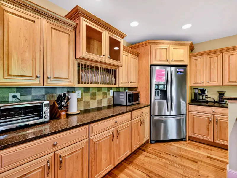 Kitchen - The full layout: island, range wall, fridge corner, all open to the main living areas.