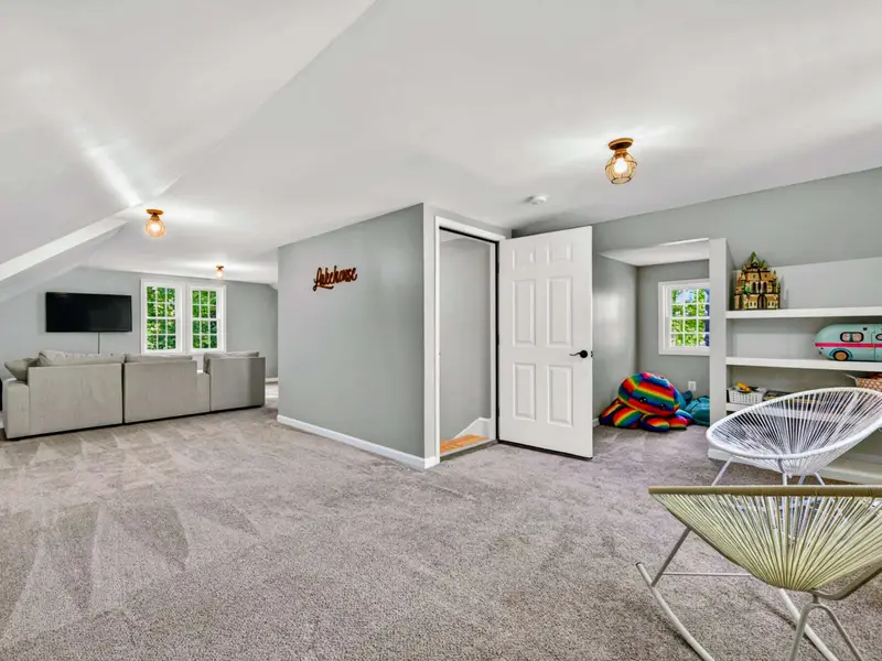 Bonus Room - The full open floor plan: sitting area in front, multiple beds tucked along the eaves.