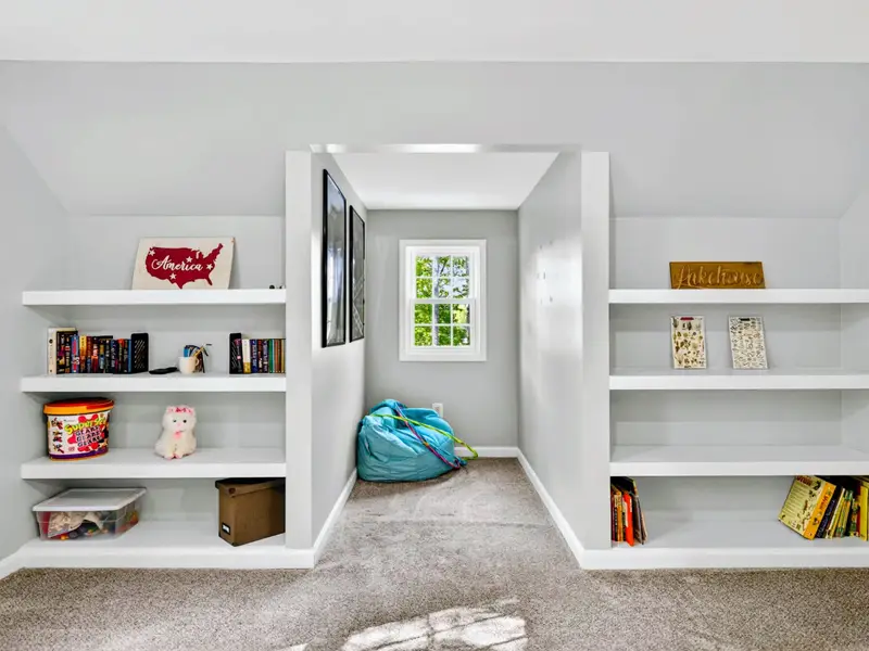 Bonus Room - Tall bookshelves stocked for the kids, with the slanted ceilings adding charm.