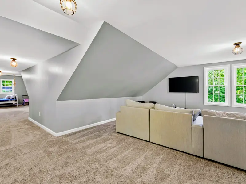 Bonus Room - The sectional anchors the lounge zone, with sleeping nooks around the perimeter.
