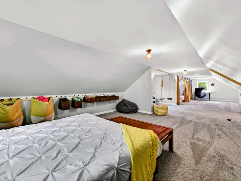 Bonus Room - Yellow accent bedding adds warmth to the kid-friendly sleeping setup.