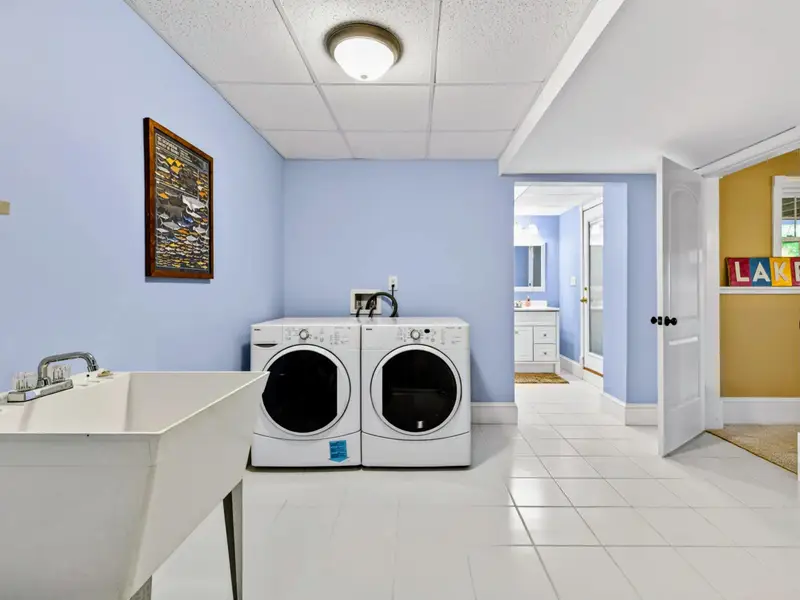 Laundry Room - Full-size front-load washer and dryer plus a utility sink for sandy beach towels and lake gear.