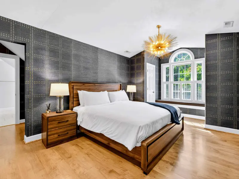 King Bedroom - Dark-denim grid wallpaper anchors this upper-level king bedroom.