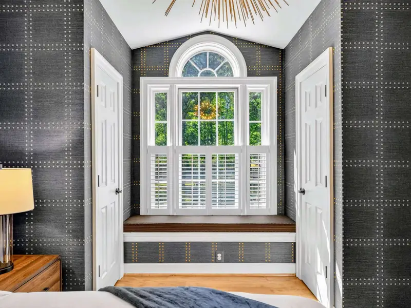 King Bedroom - Layered bedding and styled accent pieces give this room a designer touch.