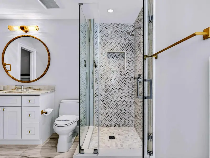 Ensuite Bath - Walk-in glass shower with marble surround.