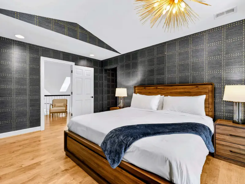 King Bedroom - View across the king bed toward the bright windows.