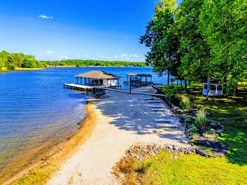 Beach - Calm water at the shoreline and the boat dock anchoring the cove.