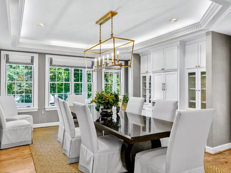 Dining Area - A long table with seating for the whole crew, framed by upholstered chairs.