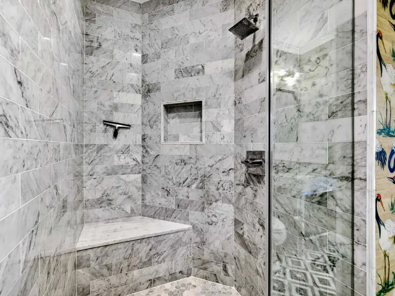 Hall Bath - Glass-enclosed walk-in shower keeps the bath feeling open and bright.