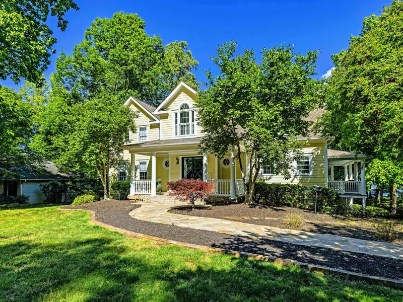 Front - The yellow facade peeks through the trees as you approach.