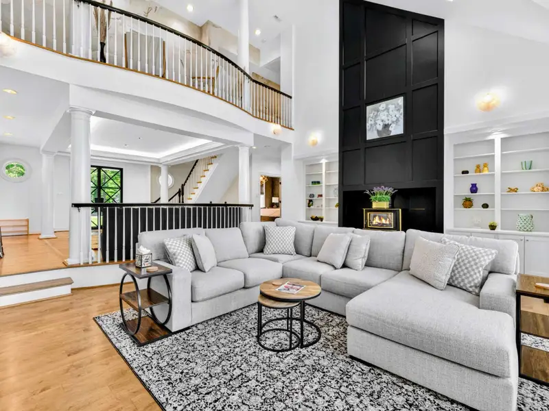 Great Room - Custom black millwork wall with built-in shelving and storage in the great room.