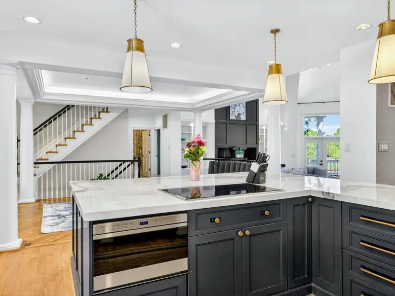 Kitchen - The full chef's setup: induction cooktop, marble counters, oversized island.