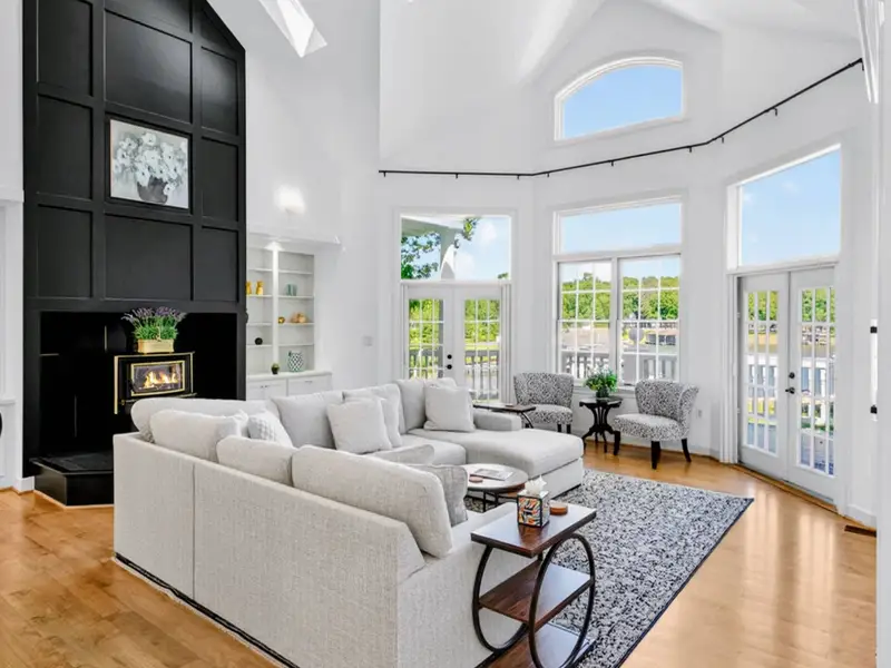 Great Room - Floor-to-ceiling windows pull the lake into every conversation.