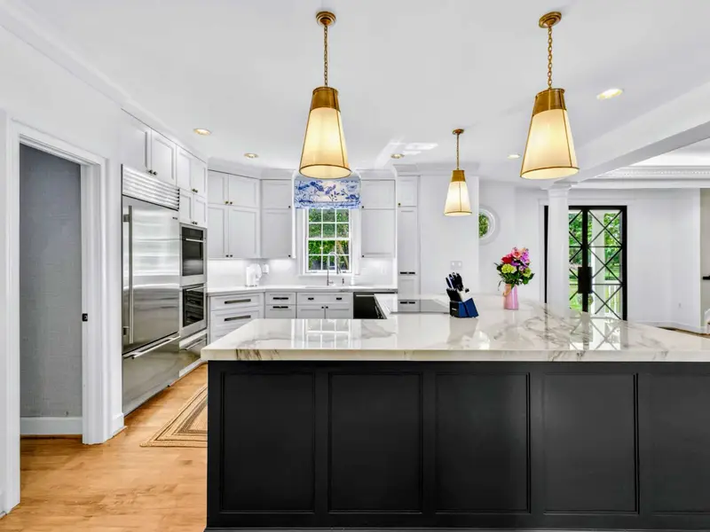 Kitchen - Long view across the island toward the appliance wall: Wolf range, Sub-Zero fridge.