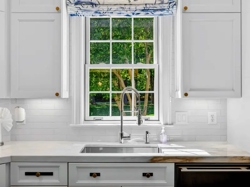 Kitchen Detail - Window over the sink frames the front yard and the basketball court.