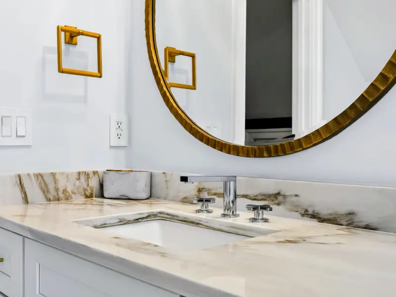 Ensuite Bath - Brass faucet on a stone-topped vanity, with quality finishes throughout.
