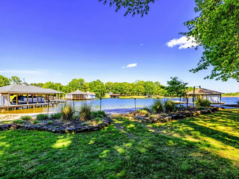 Beach - Mature shade trees and a private waterfront make the backyard feel like a small park.