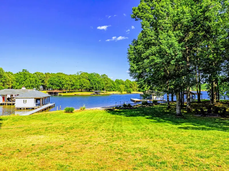 Beach - Open lawn rolls down to a quiet cove, the boat dock to one side and lake at your feet.