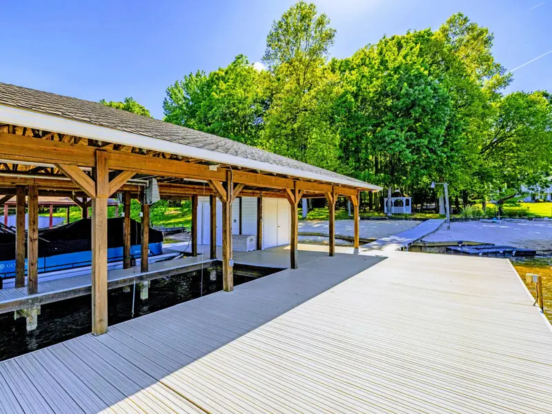 Boat Dock - Generous composite decking next to the covered slips, plenty of room for chairs and lounging.