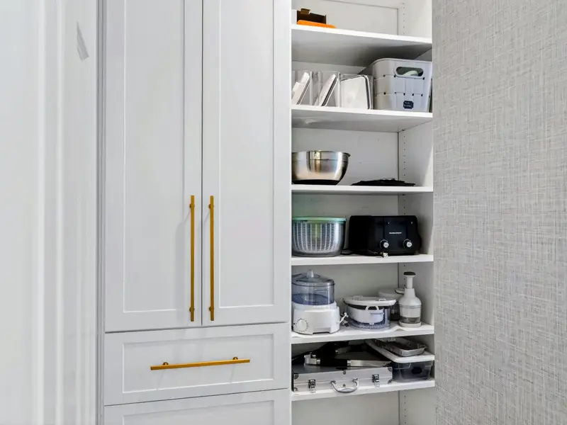 Walk-In Pantry - Floor-to-ceiling shelving with motion-activated lighting and tons of storage.