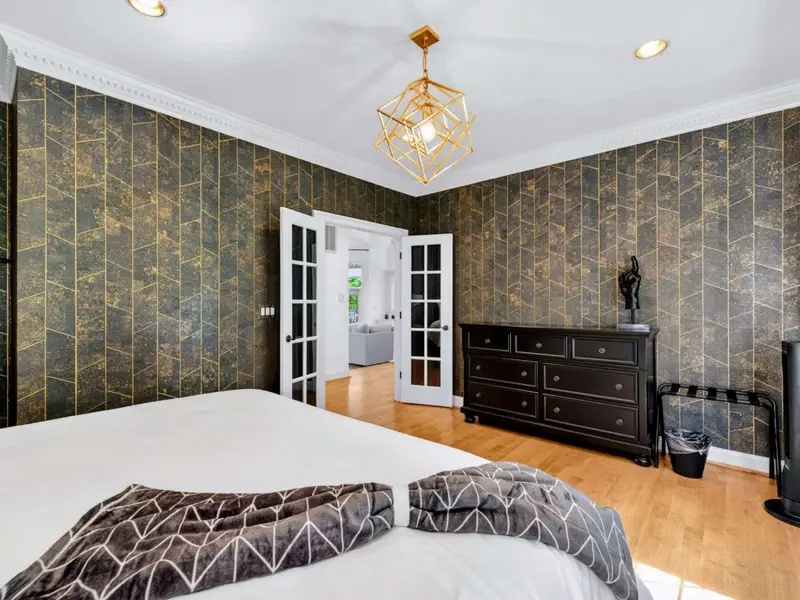 King Bedroom - French doors and bright bedding pull natural light into the bedroom.
