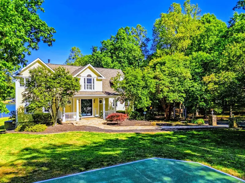 Front Yard - The home framed by mature trees on a generous lot.