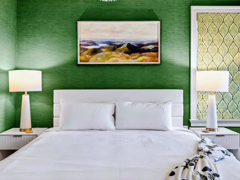 King Bedroom - A patterned roman shade and styled side tables add character to the room.