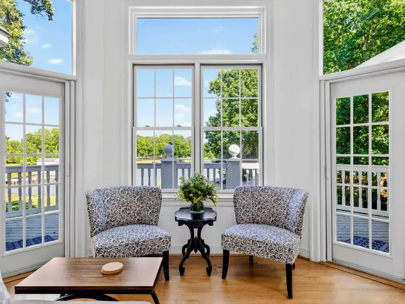 Sunroom - Wraparound windows turn this corner into a quiet lake-facing reading spot.