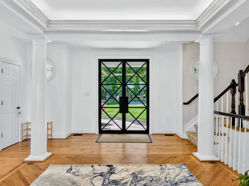Entry - French doors at the back of the great room frame the lake on every approach.