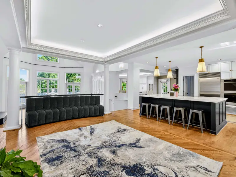 Great Room - Hardwood floors, layered rugs, and a feature wall anchor the gathering space.