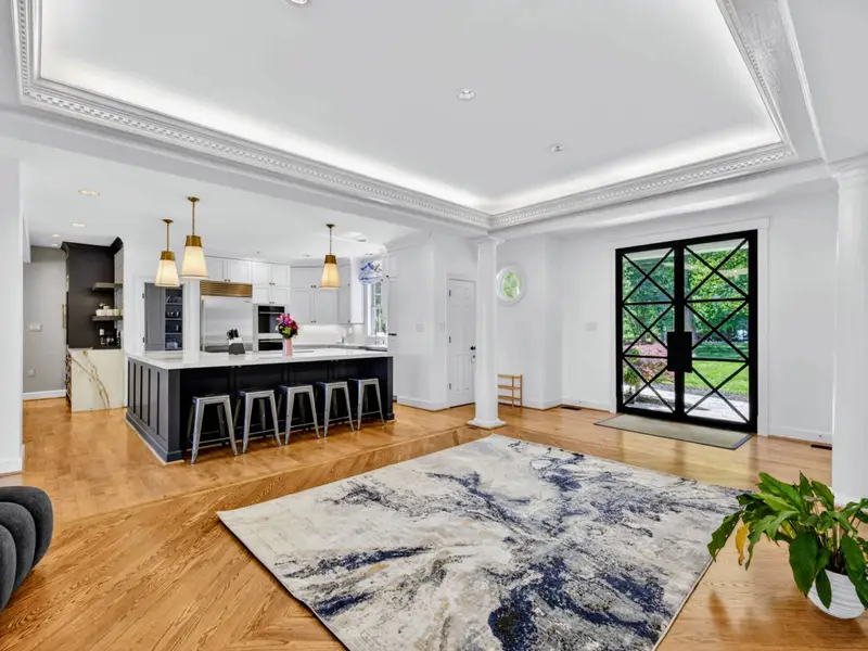 Kitchen Island - The navy island and pendant lighting are the heart of the open floor plan.