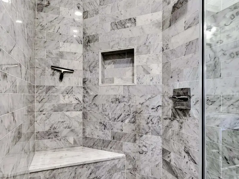 Hall Bath - Walk-in marble shower with detail tile niche.