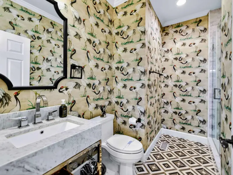 Hall Bath - Patterned floor tile and tiled walk-in shower in the main-level shared hall bath.