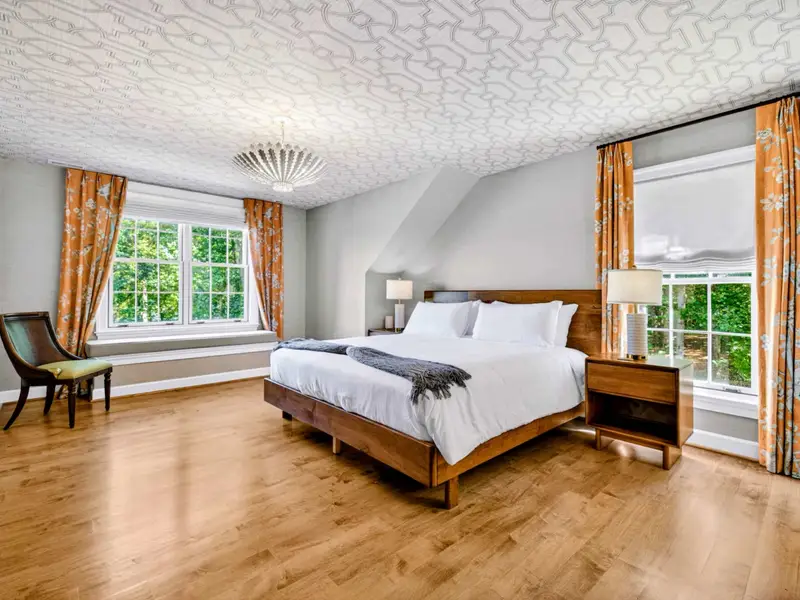 Bedroom - Warm wood floors and bright window light in this upper-level bedroom.