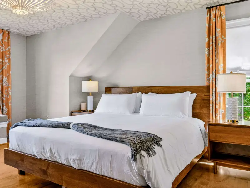 Bedroom - Upper-level bedroom with bird and floral drapery and views to the yard.