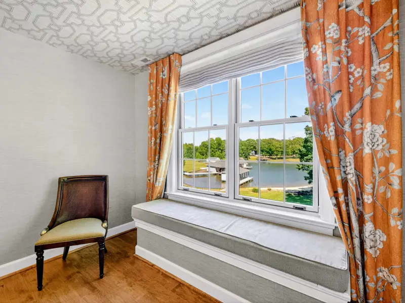 Window Seat - Built-in window seat with floral drapery, the perfect reading nook.