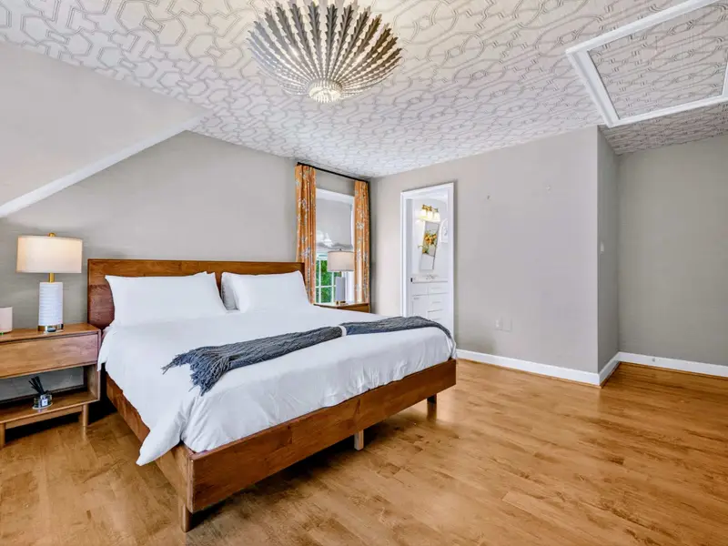Bedroom - Quiet upper-level bedroom with natural light and warm bedding.